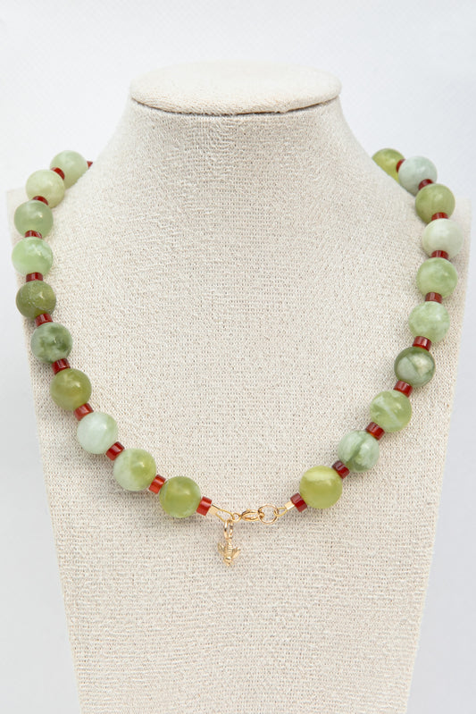 Beautiful necklace set with green serpentine and red carnelian gemstones with a dangling golden bee charm. 